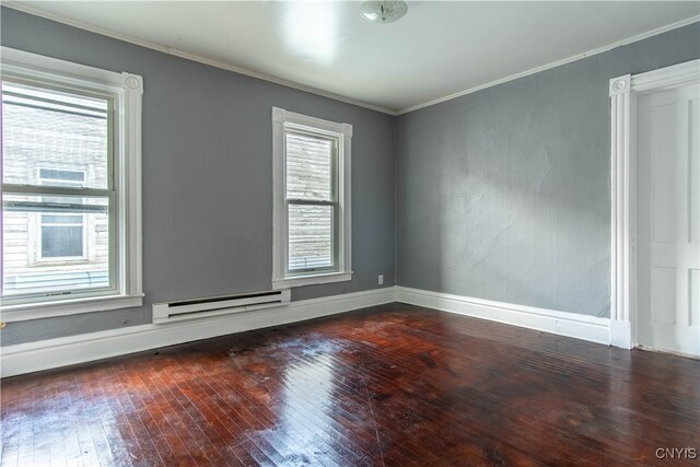 unfurnished room featuring hardwood / wood-style flooring, a baseboard radiator, a wealth of natural light, and crown molding