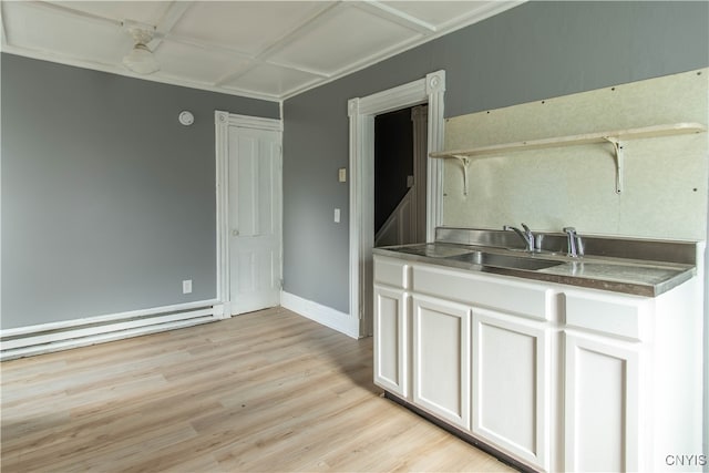 kitchen with baseboard heating, stainless steel counters, sink, light hardwood / wood-style floors, and white cabinetry