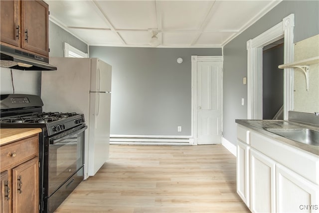 kitchen featuring black gas stove, light hardwood / wood-style floors, baseboard heating, and sink