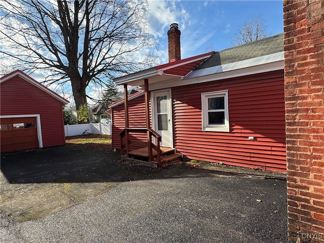 view of side of property with a garage and an outdoor structure