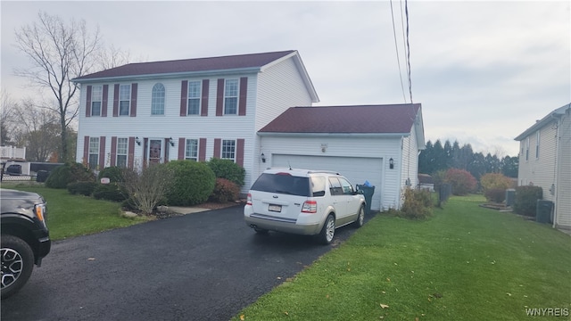 view of front of property with a garage and a front lawn