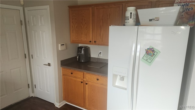 kitchen with white refrigerator with ice dispenser