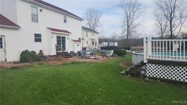 rear view of house featuring a yard