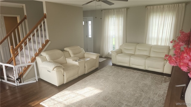 living room with dark hardwood / wood-style floors and ceiling fan