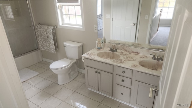 full bathroom featuring toilet, vanity, tile patterned floors, and shower / bath combination with glass door