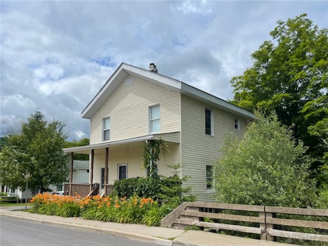 view of side of property with covered porch