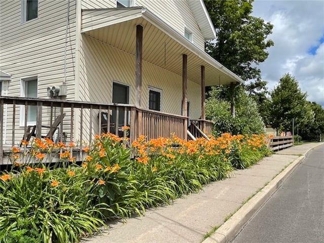 view of side of home featuring a porch