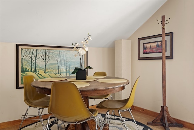 dining area featuring light hardwood / wood-style floors and lofted ceiling