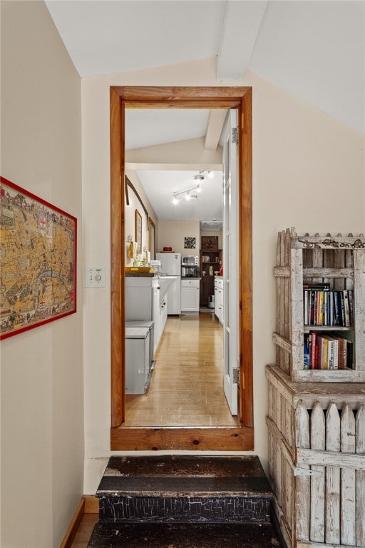 corridor featuring lofted ceiling with beams and light hardwood / wood-style floors