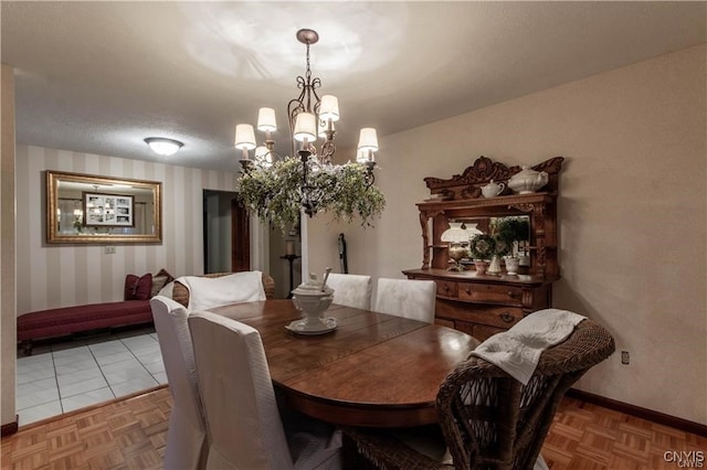 dining room featuring parquet flooring and an inviting chandelier