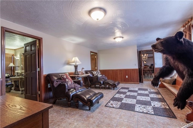 sitting room featuring light tile patterned floors and a textured ceiling