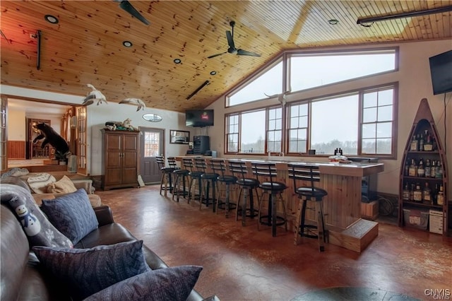 interior space featuring ceiling fan, plenty of natural light, and wood ceiling