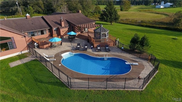 view of pool featuring a lawn and a patio area