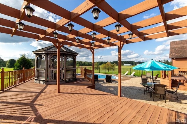 wooden terrace featuring a pergola and a gazebo