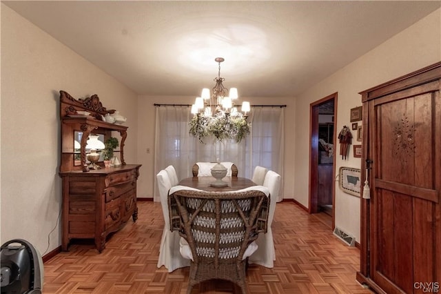 dining area featuring an inviting chandelier and light parquet floors