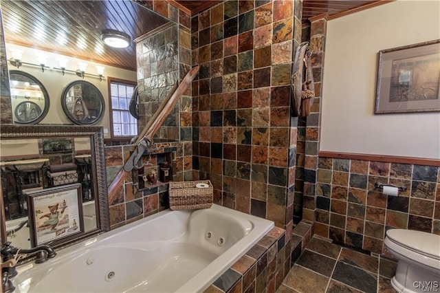 bathroom featuring tiled tub, crown molding, tile walls, and toilet