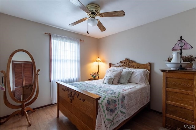 bedroom featuring dark hardwood / wood-style floors and ceiling fan