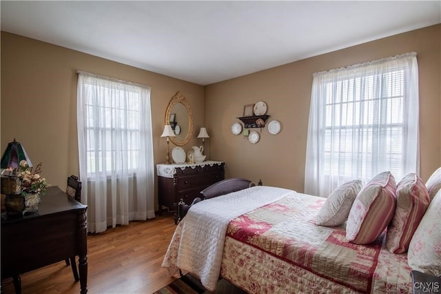 bedroom with hardwood / wood-style flooring