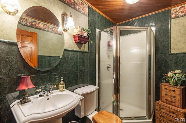 bathroom featuring an enclosed shower, tile walls, and sink