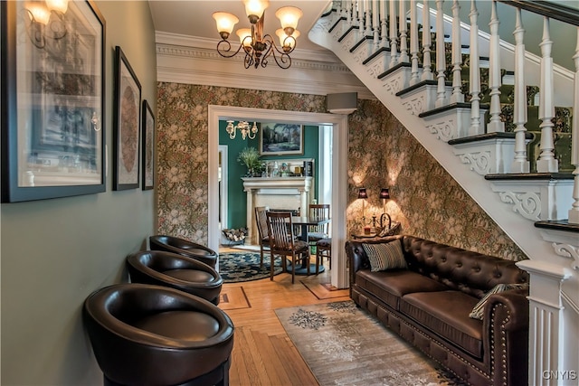 living area with parquet flooring, ornamental molding, and a notable chandelier