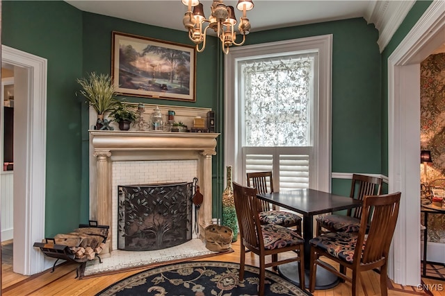 dining area with a fireplace, plenty of natural light, and wood-type flooring