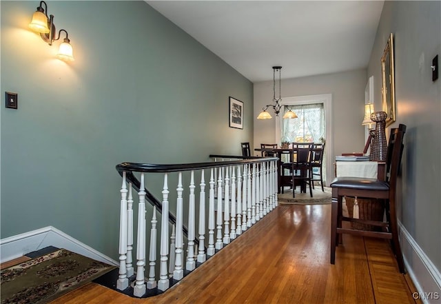 8 E Park, Kirkland, NY 13323 - hall featuring an upstairs landing, wood finished floors, baseboards, and a chandelier