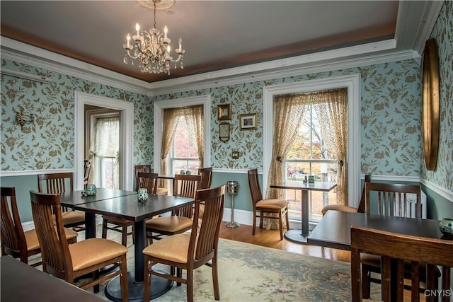 8 E Park, Kirkland, NY 13323 - dining area with wallpapered walls, a chandelier, wood finished floors, a wainscoted wall, and crown molding