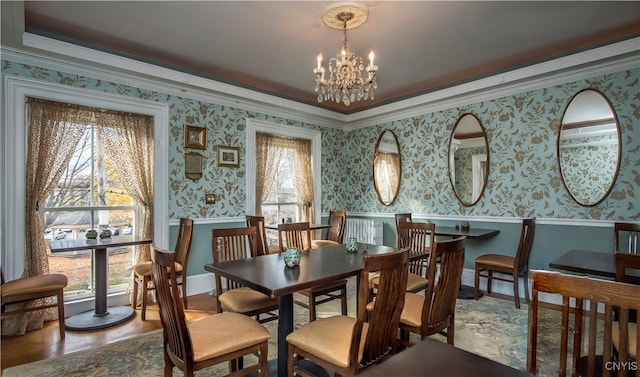 dining area featuring hardwood / wood-style flooring, crown molding, and a chandelier