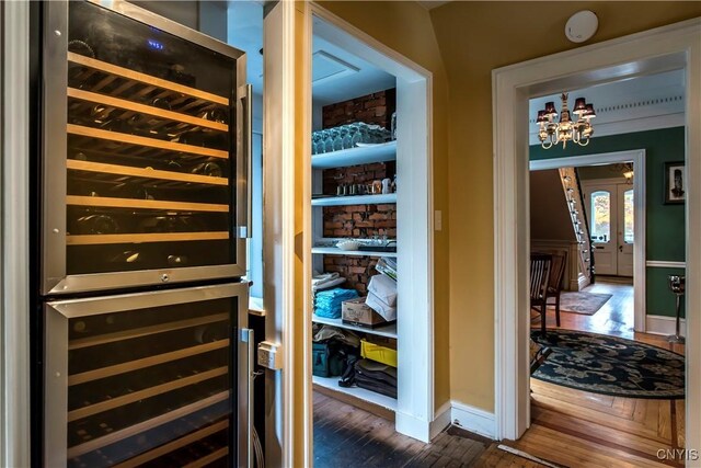 8 E Park, Kirkland, NY 13323 - interior space featuring wine cooler, dark wood-style flooring, a chandelier, and baseboards