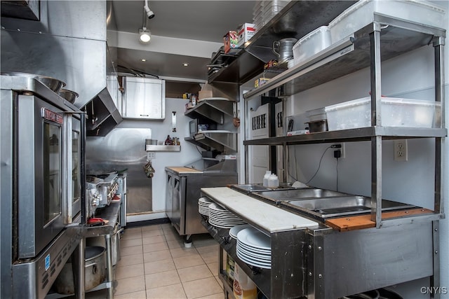 kitchen with stainless steel refrigerator and light tile patterned flooring