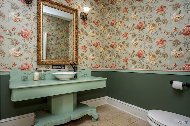 8 E Park, Kirkland, NY 13323 - half bathroom featuring wallpapered walls, baseboards, a sink, toilet, and tile patterned floors