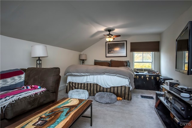 carpeted bedroom with ceiling fan and vaulted ceiling