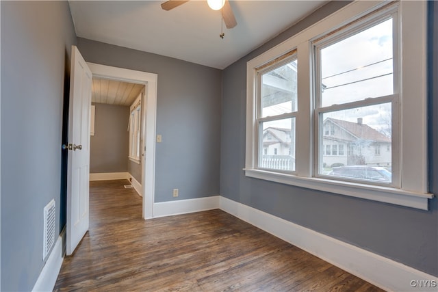 unfurnished room featuring ceiling fan and dark hardwood / wood-style flooring