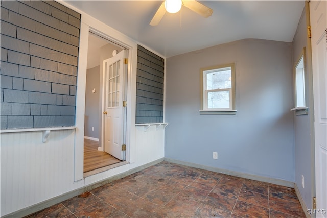 interior space with ceiling fan