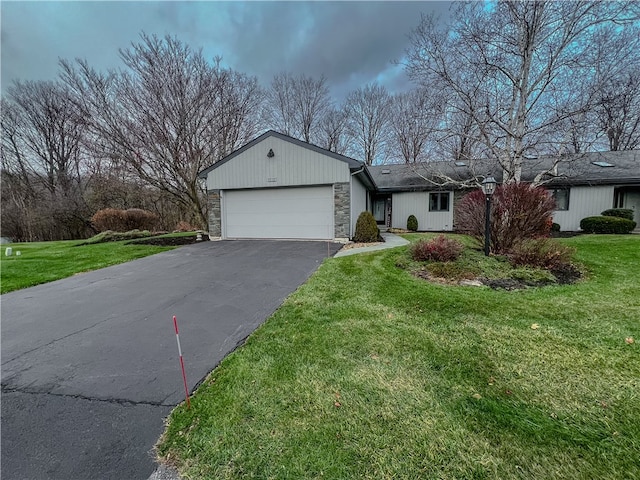 single story home featuring a garage and a front yard