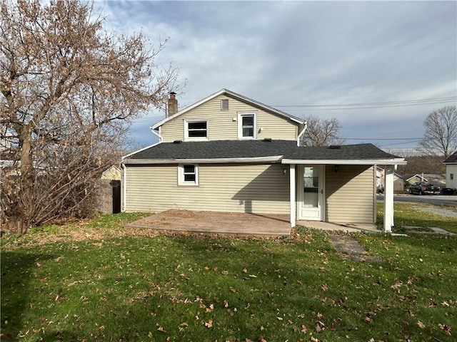 19 Jay St, Phelps, NY 14532 - back of property with a yard, a chimney, a patio area, and a shingled roof