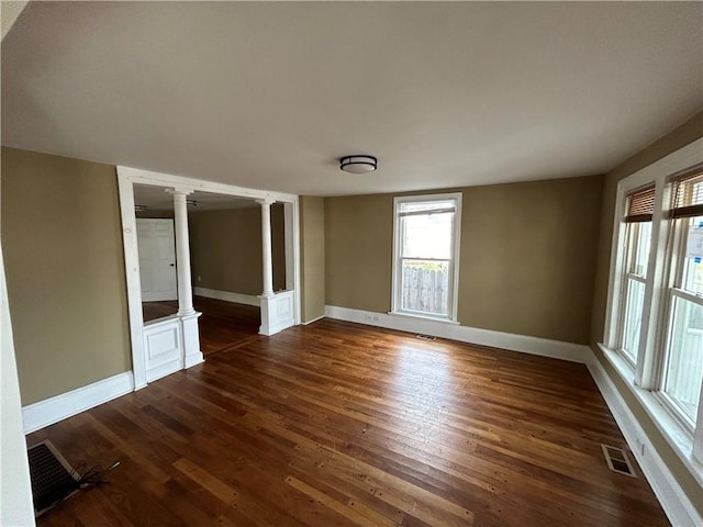 19 Jay St, Phelps, NY 14532 - empty room with decorative columns and dark wood-type flooring