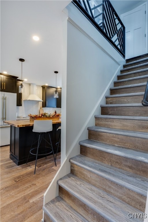 staircase featuring hardwood / wood-style floors