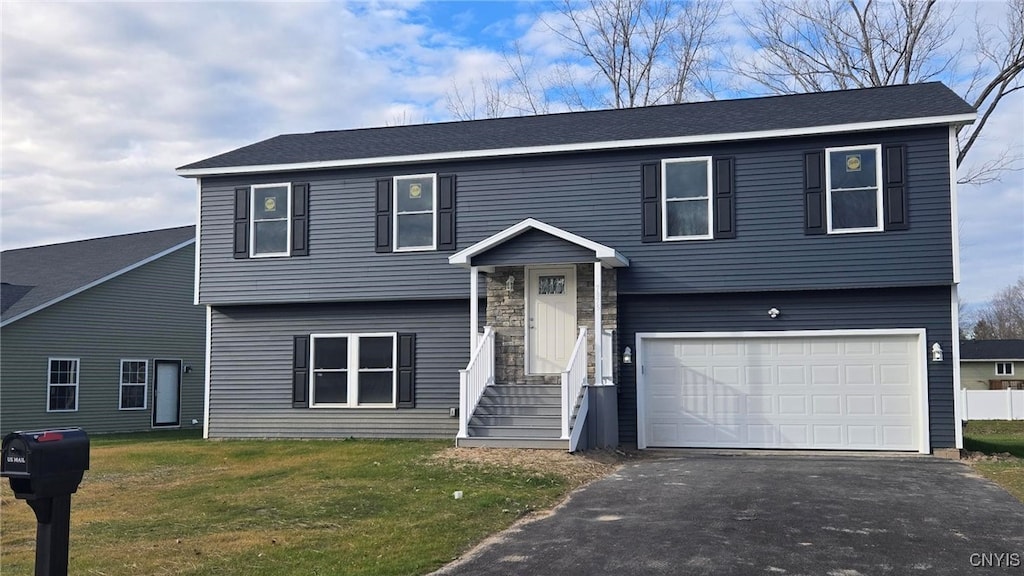 split foyer home with a front yard and a garage