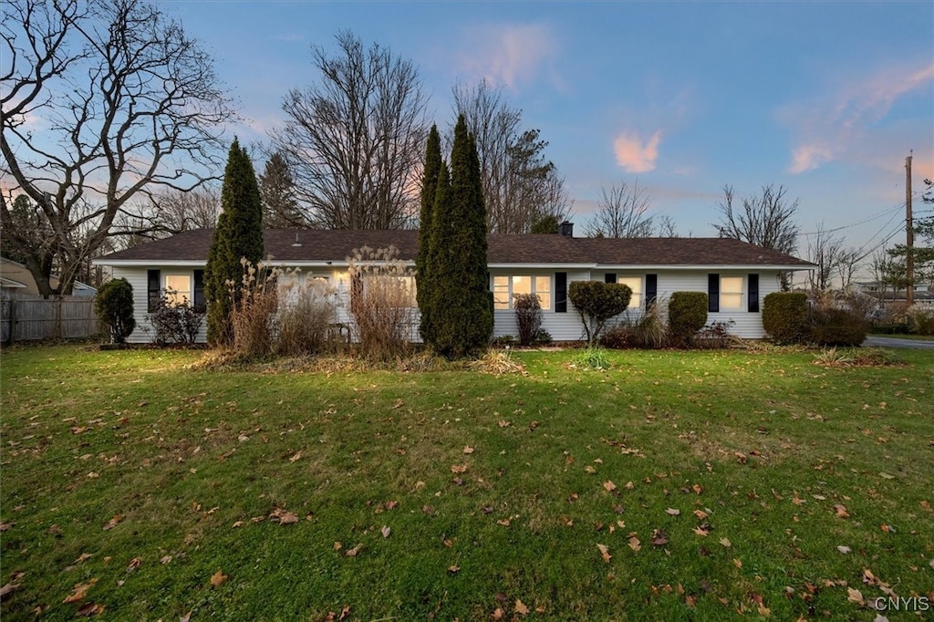 ranch-style home featuring a yard