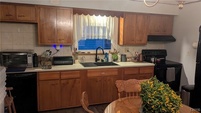 kitchen featuring black appliances, backsplash, sink, and extractor fan