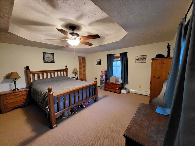 carpeted bedroom featuring a tray ceiling, ceiling fan, a baseboard radiator, and a textured ceiling