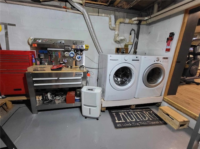 washroom featuring independent washer and dryer and a workshop area