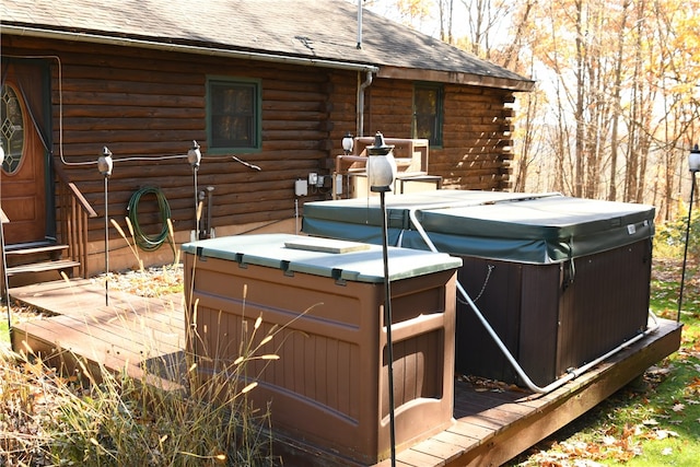 wooden deck with a hot tub