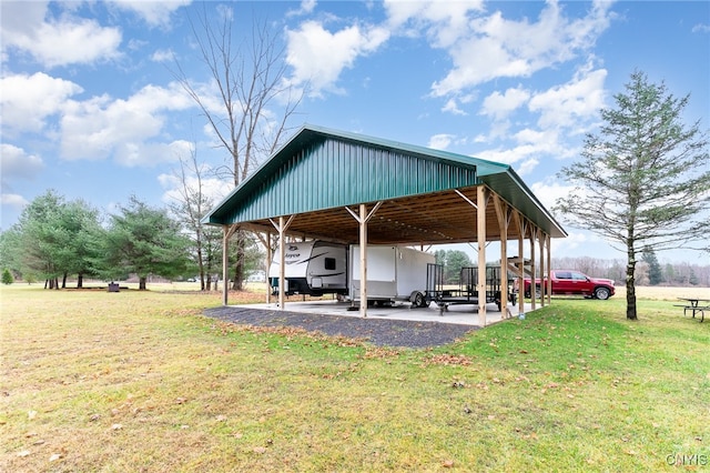 view of parking featuring a yard and a carport