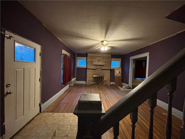 living room with a fireplace, hardwood / wood-style flooring, and ceiling fan