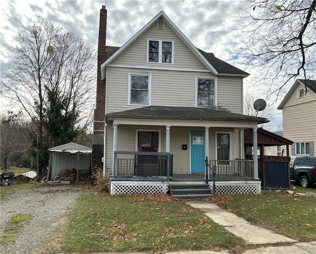 front facade with a front lawn and a porch