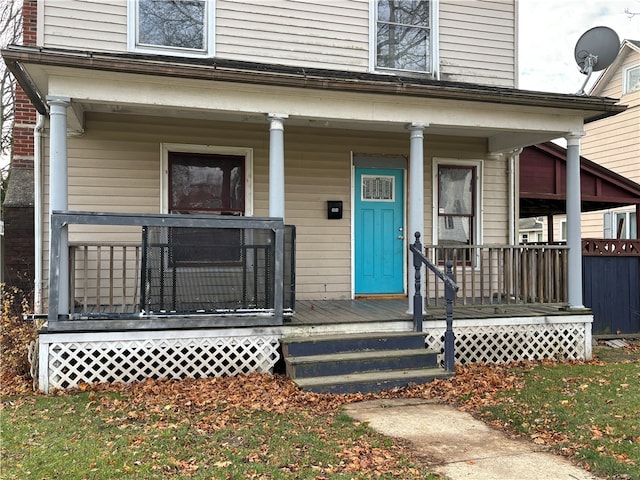 view of exterior entry featuring a porch