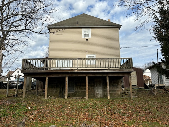 rear view of house featuring a wooden deck