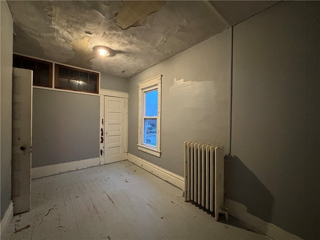 interior space with radiator and light wood-type flooring